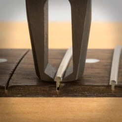 StewMac Precision Fret Puller - StewMac -Fine Musical Instruments 1636 4 close up pulling 3000px