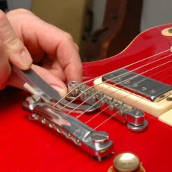 Tune-o-Medic Bridge And Tailpiece Tools - StewMac -Fine Musical Instruments 4557 5 in use 2000px